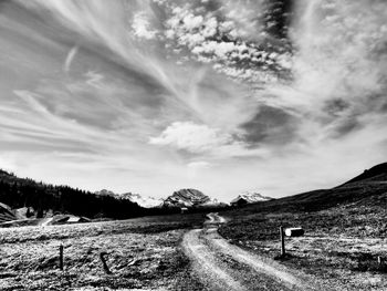 Road by landscape against sky