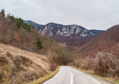 Road amidst mountains against sky