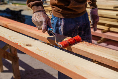 Midsection of man working on wood