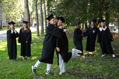 Rear view of couple standing in park