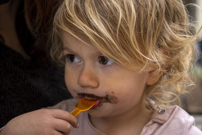 Close-up portrait of boy eating