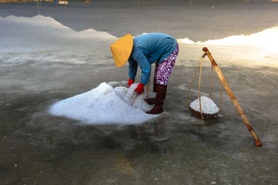 Full length of woman working at salt flat