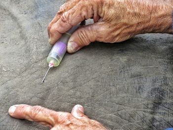 High angle view of people holding hands on table
