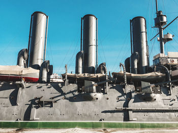 Low angle view of industry against blue sky