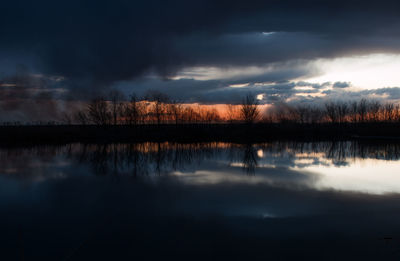 Reflection of clouds in lake at sunset