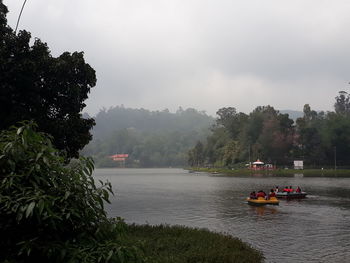 View of boats in water against sky