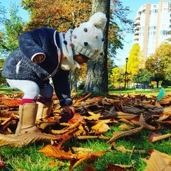 Midsection of man standing by tree during autumn