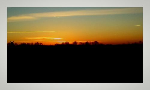 Silhouette landscape against sky during sunset