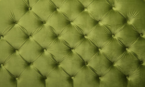 Full frame image of green chesterfield furniture