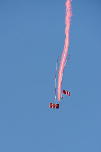 Low angle view of airplane flying against clear blue sky