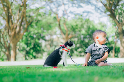 Full length of boy with cat at park