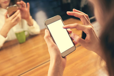 Midsection of woman using mobile phone