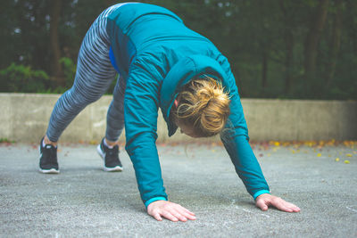 Woman exercising on road