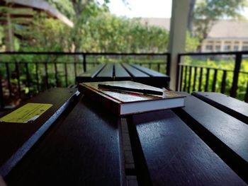 Close-up of open book on table by window