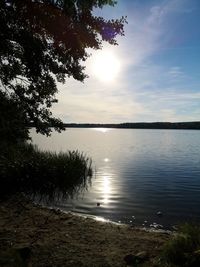 Scenic view of lake against sky at sunset