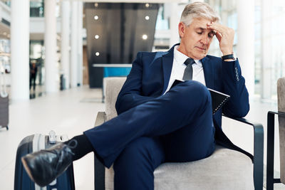 Full length of man sitting in office