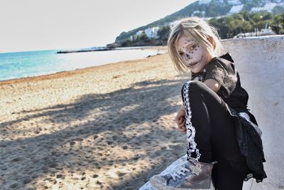 Girl with facepaint on beach