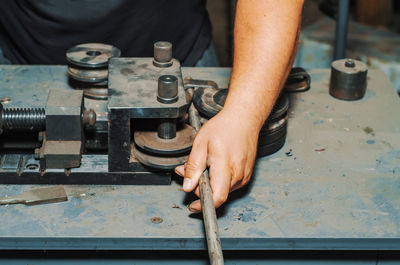 Cropped hand of man working at factory