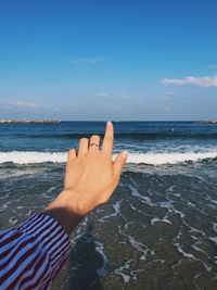 Midsection of person hand on beach