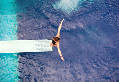 High angle view of woman swimming in pool