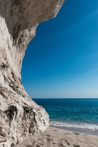 Scenic view of sea against clear blue sky