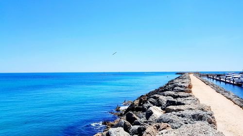 Scenic view of sea against clear blue sky