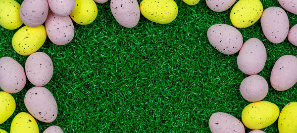 High angle view of multi colored eggs on grass