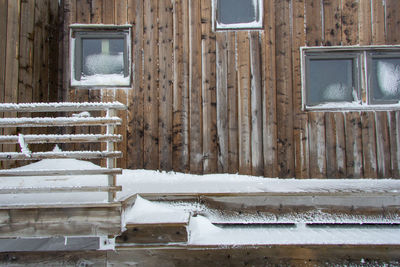Abandoned house by window during winter