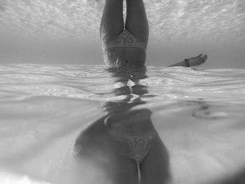 Low section of woman underwater with dreams
