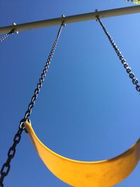 Low angle view of chain against sky