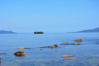 Scenic view of sea against clear blue sky