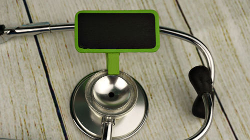 Stethoscope with blank board on wooden table