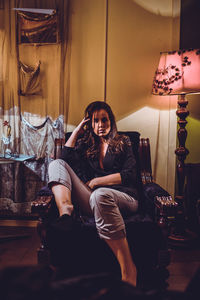 Portrait of a smiling young woman sitting on chair