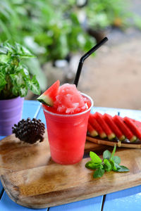 High angle view of drink by watermelon on table