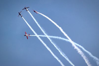 Low angle view of airshow against sky