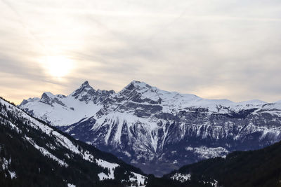 Scenic view of snowcapped mountains against sky