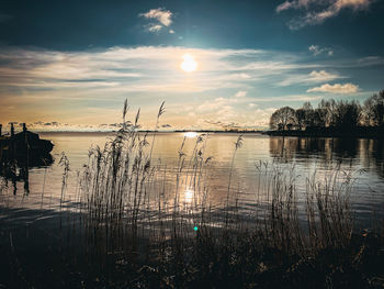 Scenic view of lake against sky during sunset