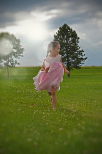 Full length of girl standing on grassy field
