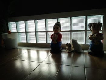 Young woman sitting by window at home