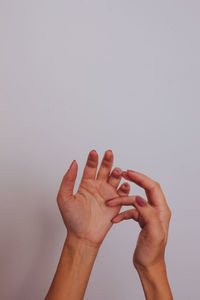 Close-up of woman hand over white background