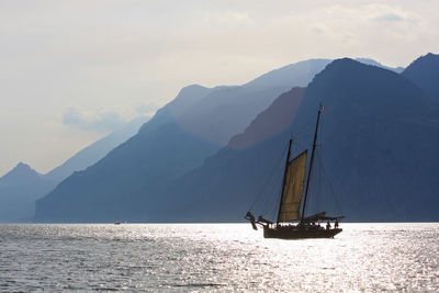 Sailboat sailing on sea against sky