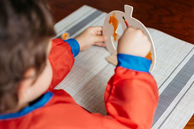 High angle view of man playing with toy at home