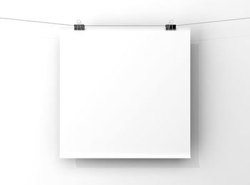 Low angle view of empty paper against white wall