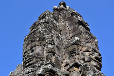 Low angle view of sculpture against clear blue sky