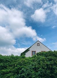 Low angle view of house and trees against sky