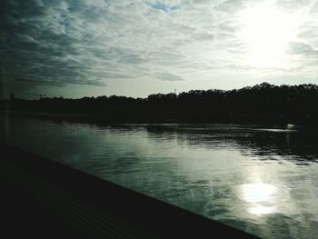 Scenic view of lake against sky at sunset