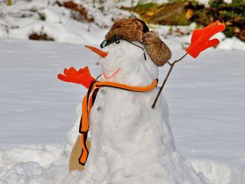 Midsection of snowman on landscape