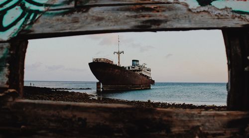 Abandoned ship at sea against sky