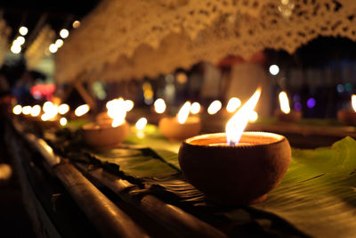 Close-up of illuminated diya at night