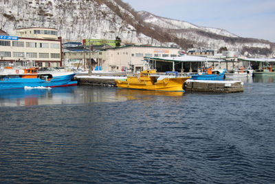 Boats moored in sea against sky